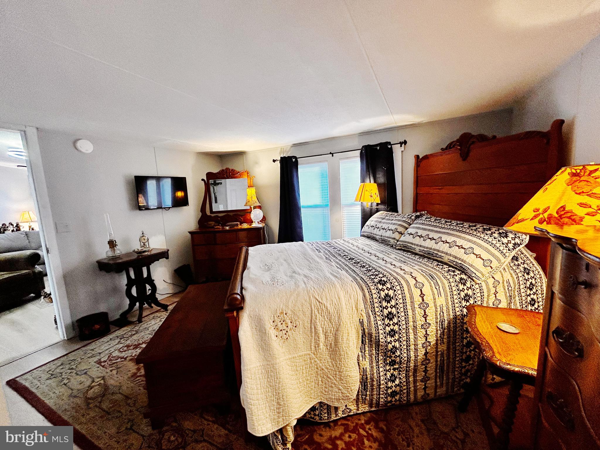 260 Marshall Mill Road, Unit 146 Malaga, NJ 08328 - Photo 15 of 22 a bedroom with a bed and wooden floor