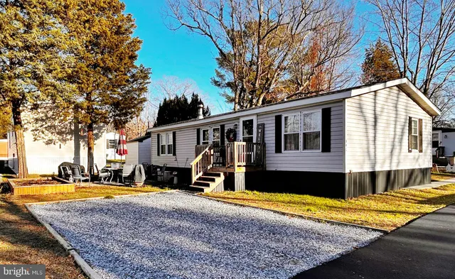 a view of a house with a swimming pool and sitting area