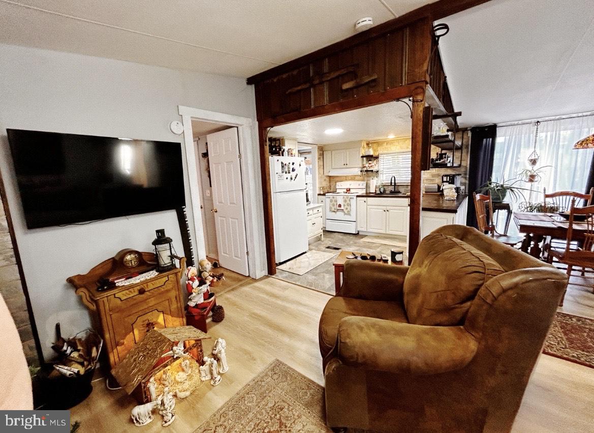 260 Marshall Mill Road, Unit 146 Malaga, NJ 08328 - Photo 8 of 22 a living room with furniture and a flat screen tv