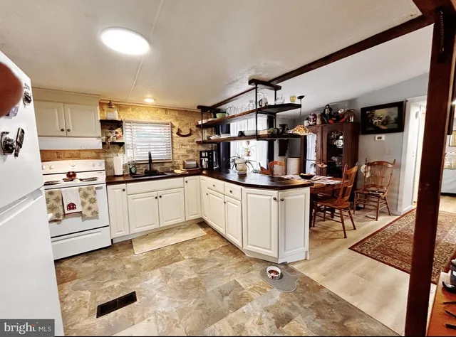 a kitchen with white cabinets and white appliances