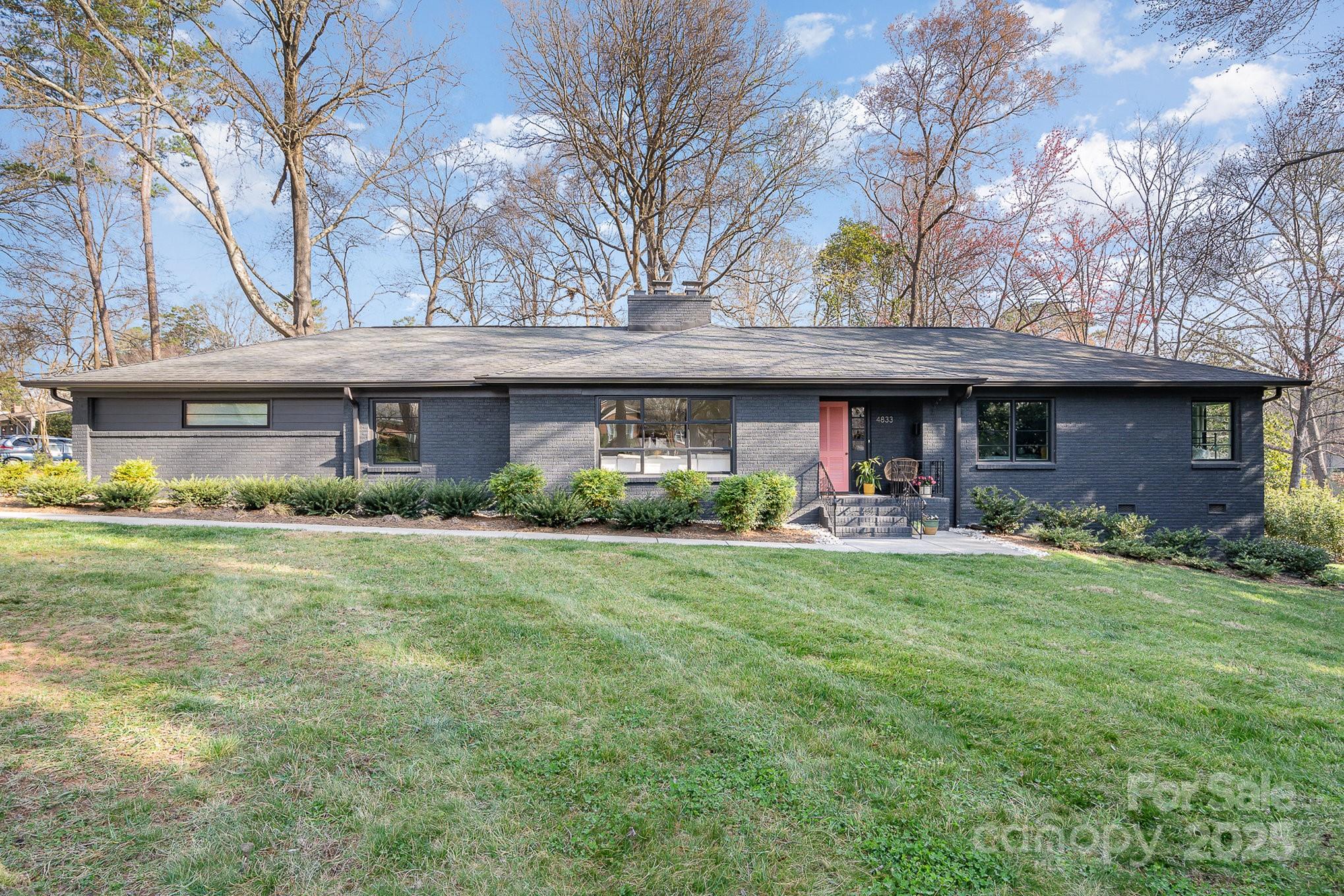 a front view of a house with swimming pool having outdoor seating