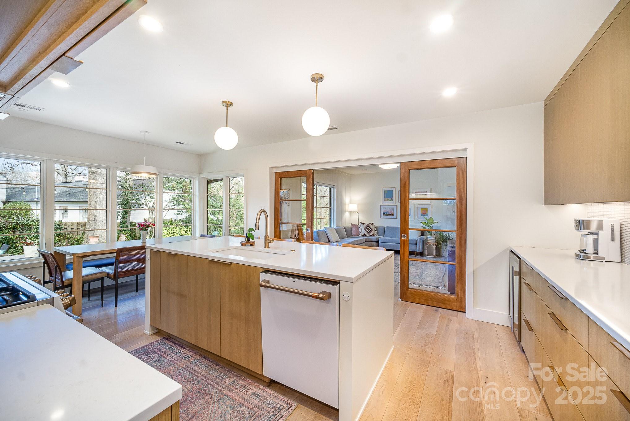 4833 Addison Drive Charlotte, NC 28211 - Photo 16 of 47 a large room with kitchen island a large window a sink and living room view