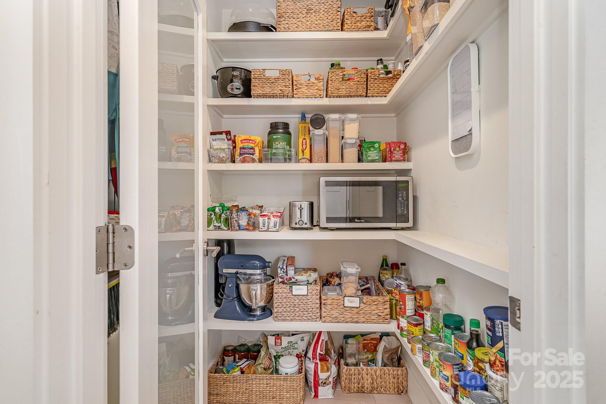 4833 Addison Drive Charlotte, NC 28211 - Photo 23 of 47 a shelf with books and a kitchen view