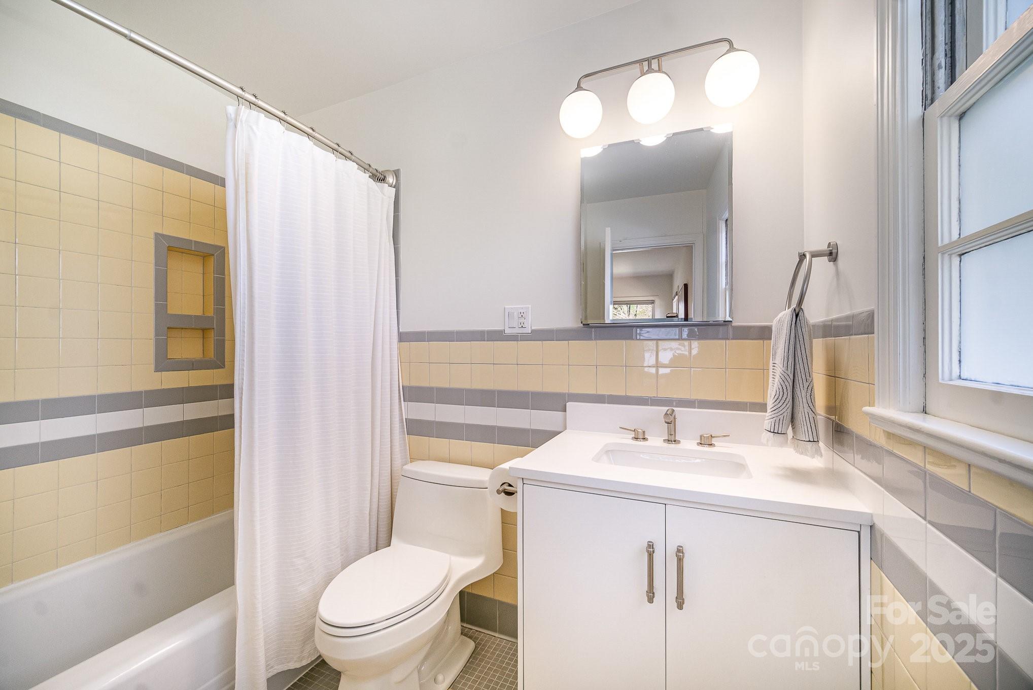 4833 Addison Drive Charlotte, NC 28211 - Photo 37 of 47 a bathroom with a sink vanity mirror and toilet