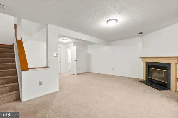a view of an empty room with a fireplace