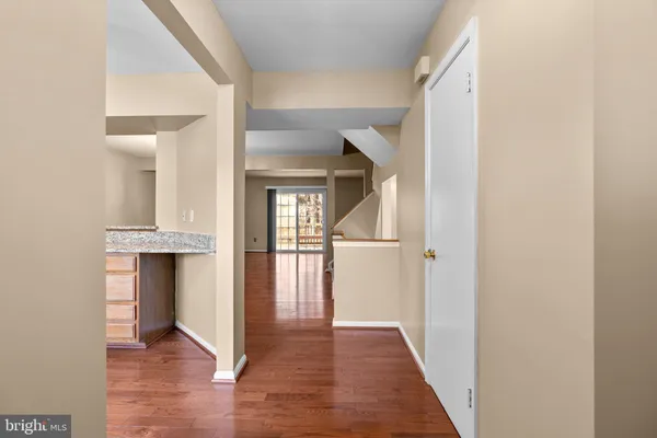 a view of hallway with wooden floor