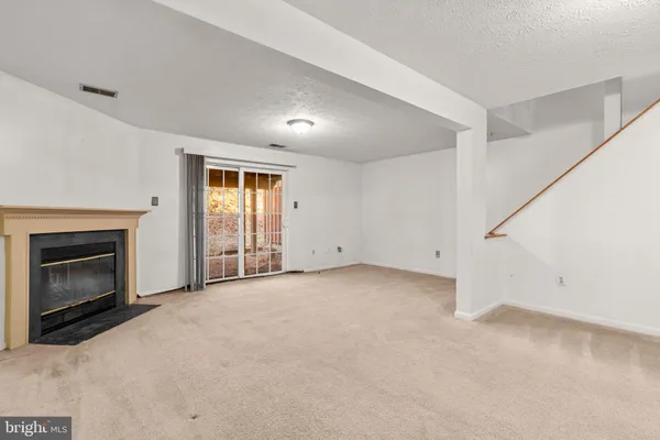 a view of empty room with a fireplace