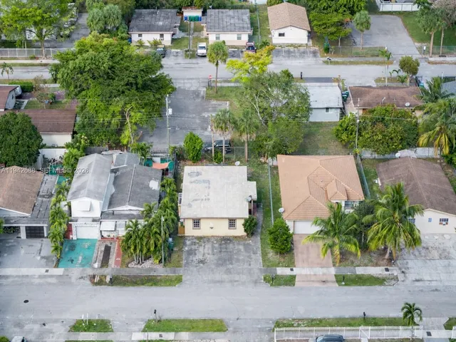 an aerial view of residential houses with outdoor space and street view