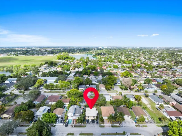 an aerial view of residential houses with outdoor space