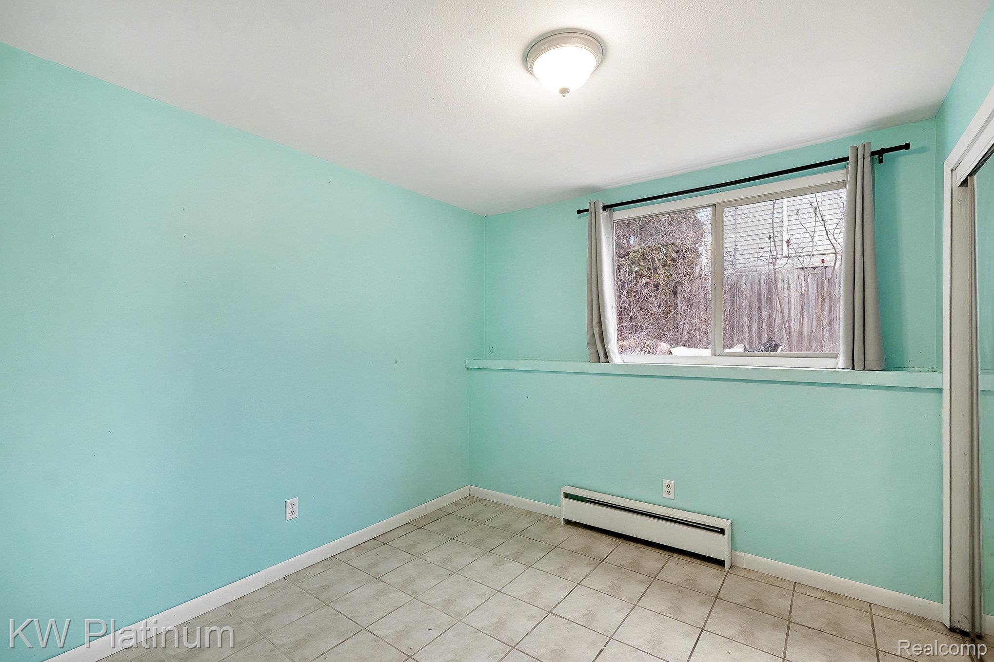 185 Michelson Road Rochester, MI 48307 - Photo 28 of 36 Unfurnished room featuring a baseboard heating unit and tile patterned floors