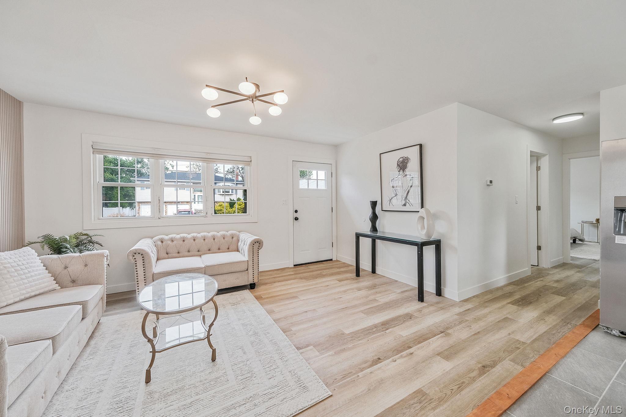 120 Manhattan Avenue West Babylon, NY 11704 - Photo 11 of 32 a living room with furniture and a wooden floor