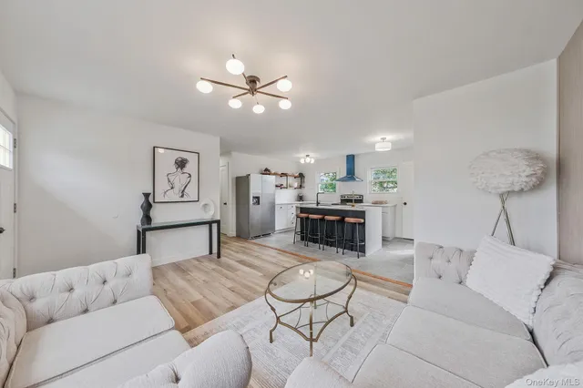 a living room with furniture and a chandelier