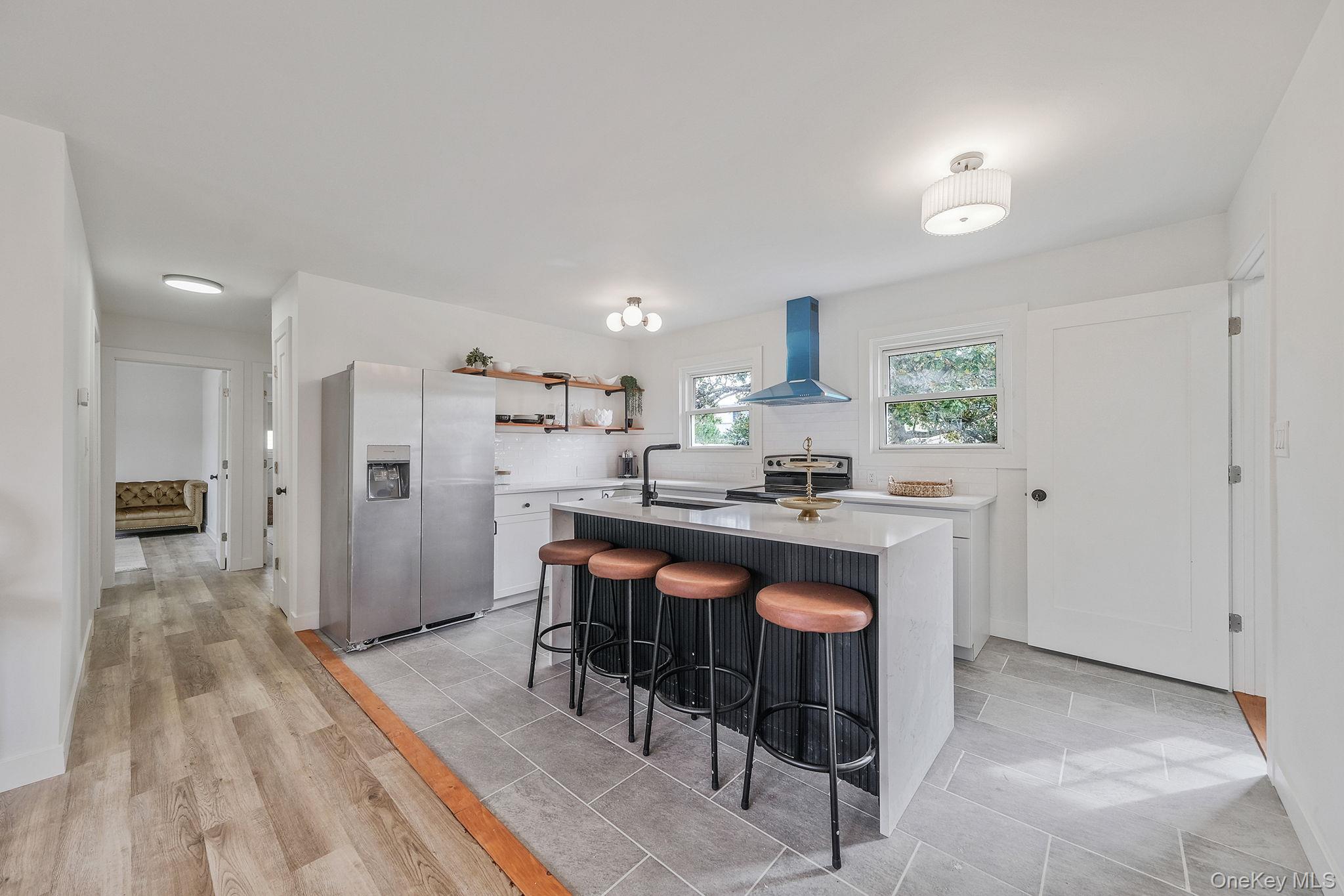 120 Manhattan Avenue West Babylon, NY 11704 - Photo 13 of 32 a kitchen with stainless steel appliances granite countertop a refrigerator a sink dishwasher and a stove with wooden floor
