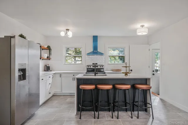 a kitchen with stainless steel appliances a sink stove and refrigerator