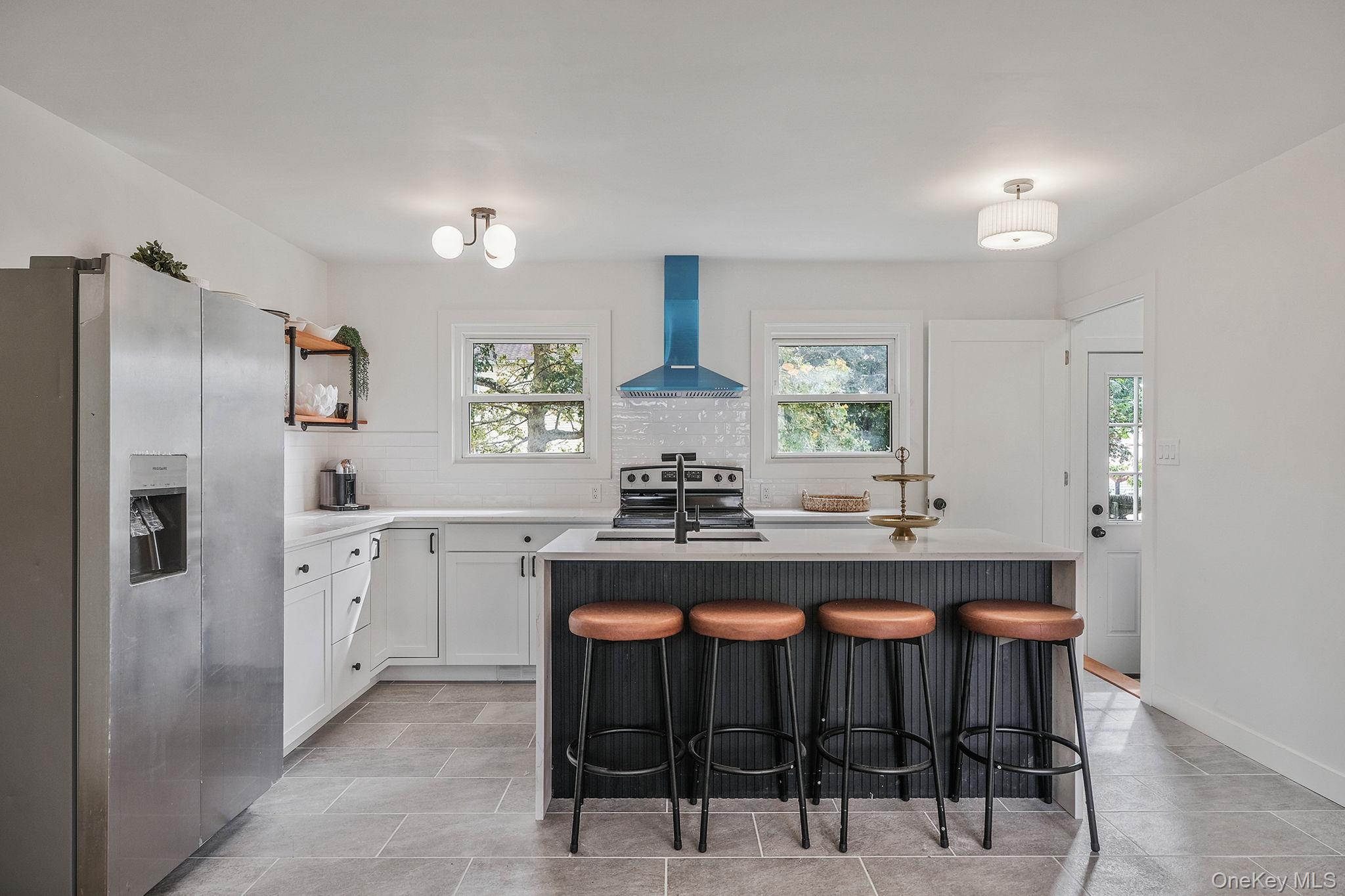 120 Manhattan Avenue West Babylon, NY 11704 - Photo 14 of 32 a kitchen with stainless steel appliances a sink stove and refrigerator