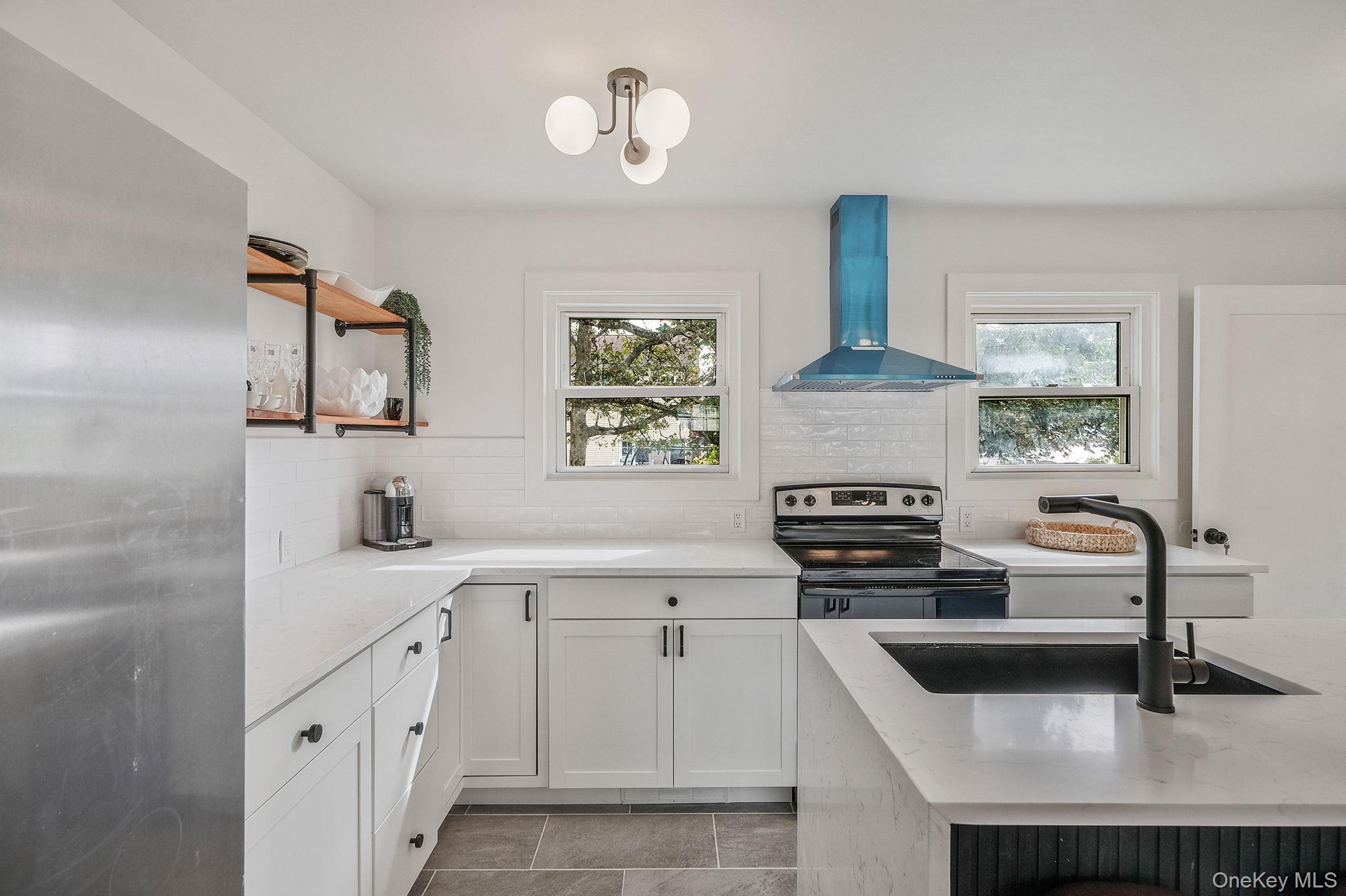 120 Manhattan Avenue West Babylon, NY 11704 - Photo 15 of 32 a kitchen with cabinets stainless steel appliances a sink and a stove