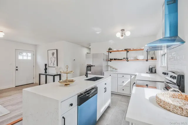 a kitchen with sink refrigerator and stove
