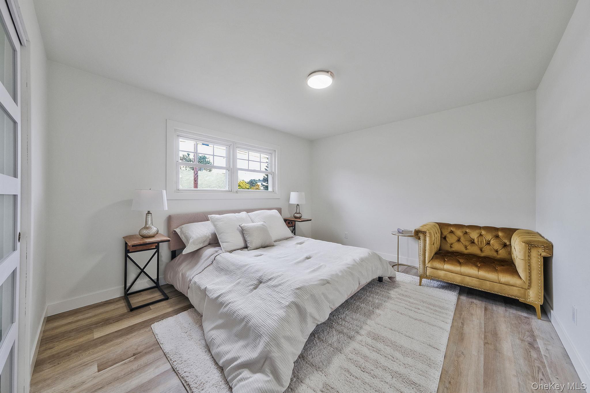 120 Manhattan Avenue West Babylon, NY 11704 - Photo 17 of 32 a bedroom with a bed and a couch