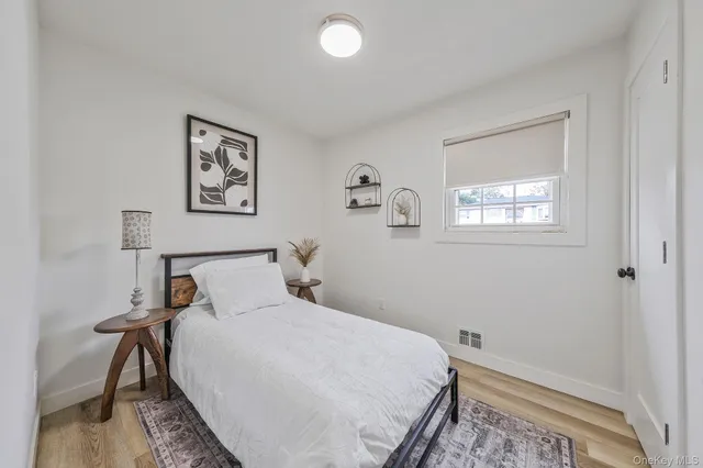 a bedroom with a bed and a chair