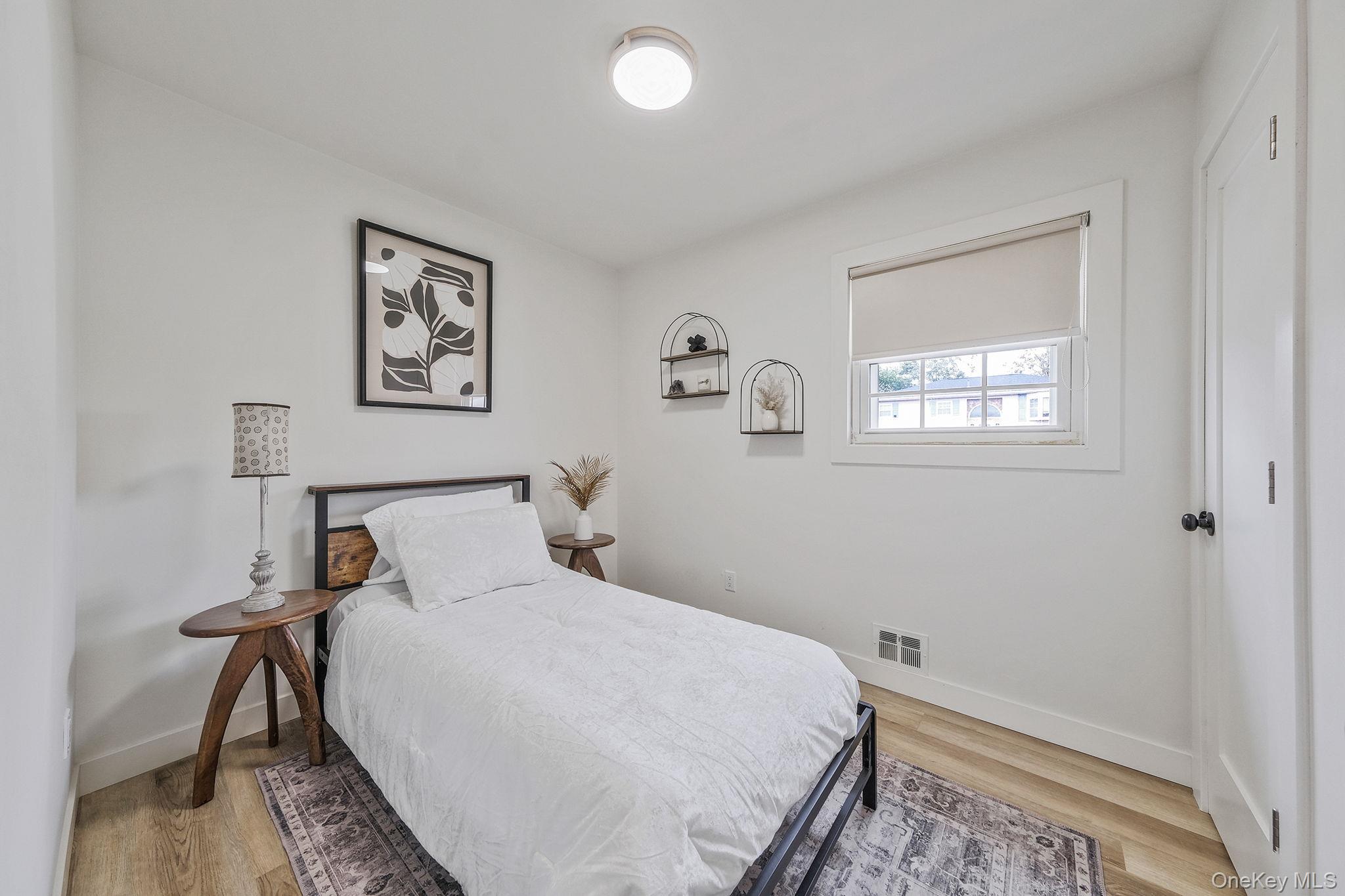 120 Manhattan Avenue West Babylon, NY 11704 - Photo 19 of 32 a bedroom with a bed and a window