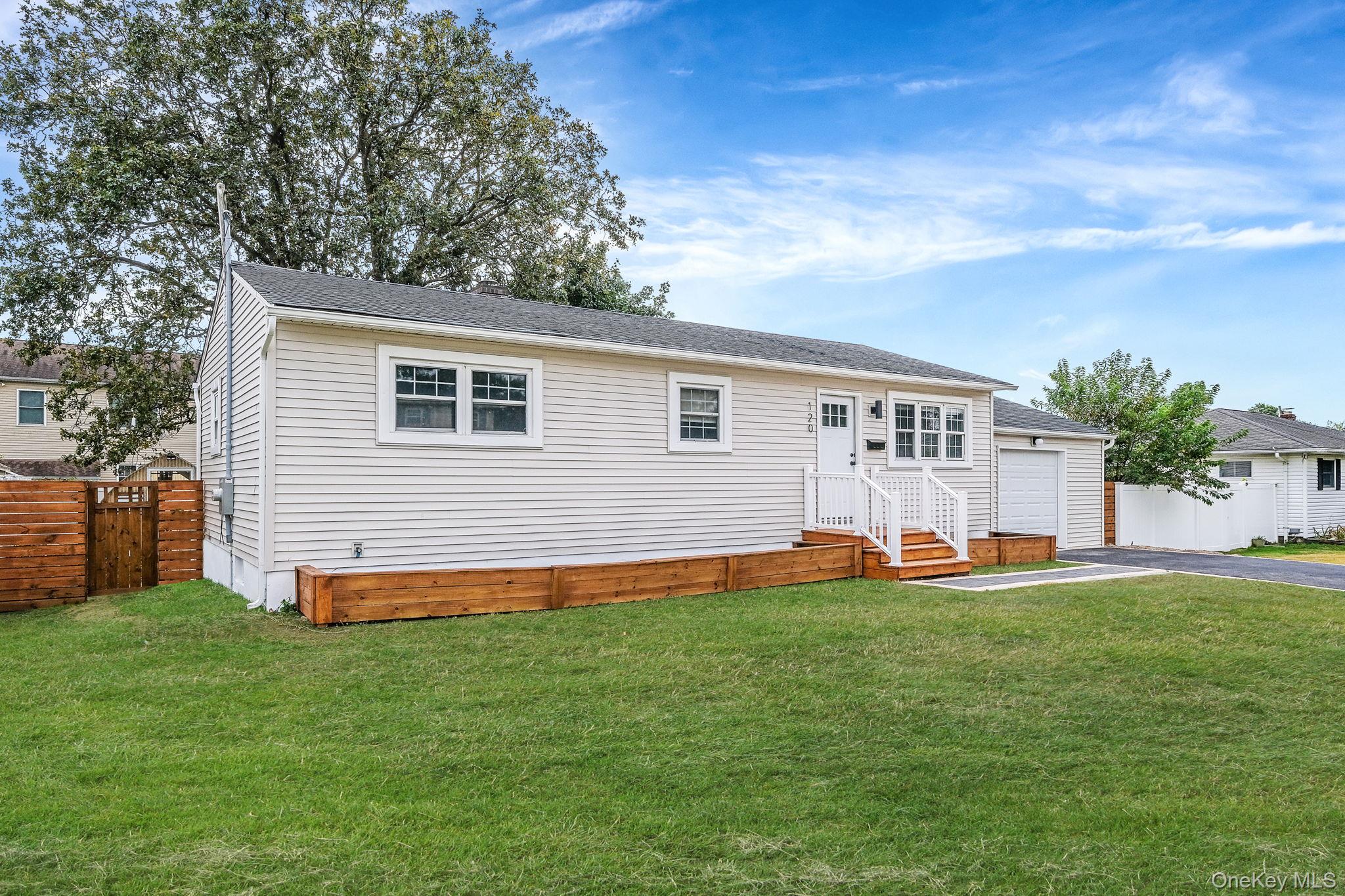120 Manhattan Avenue West Babylon, NY 11704 - Photo 2 of 32 a front view of house with yard and trees in the background