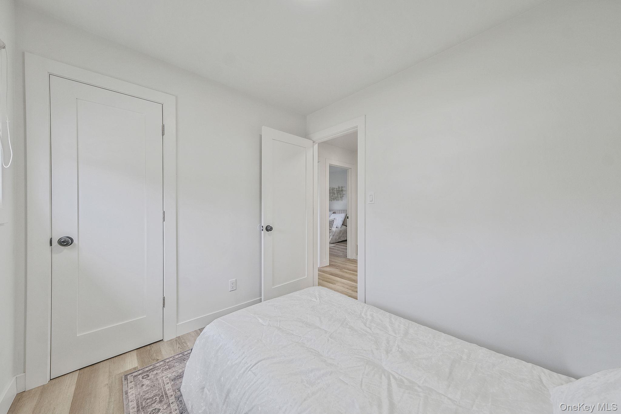 120 Manhattan Avenue West Babylon, NY 11704 - Photo 20 of 32 a bedroom with a bed and a bathroom