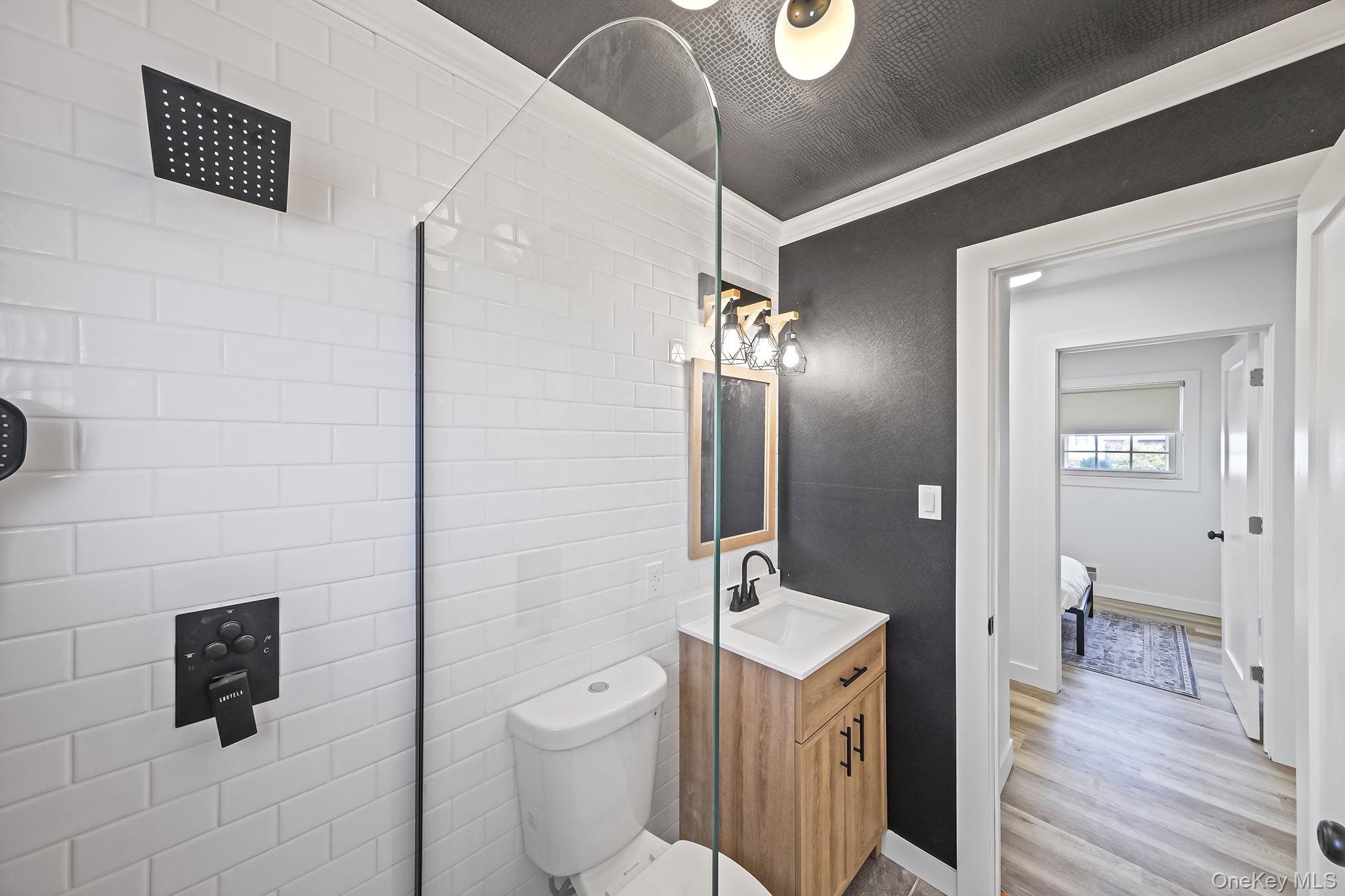 120 Manhattan Avenue West Babylon, NY 11704 - Photo 24 of 32 a spacious bathroom with a toilet a sink a mirror and a shower