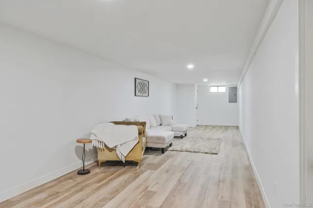 a spacious bathroom with a toilet a sink a mirror and a shower