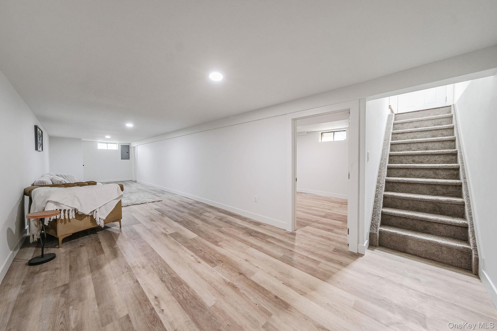 120 Manhattan Avenue West Babylon, NY 11704 - Photo 26 of 32 a view of a bedroom with wooden floor and lounge chairs