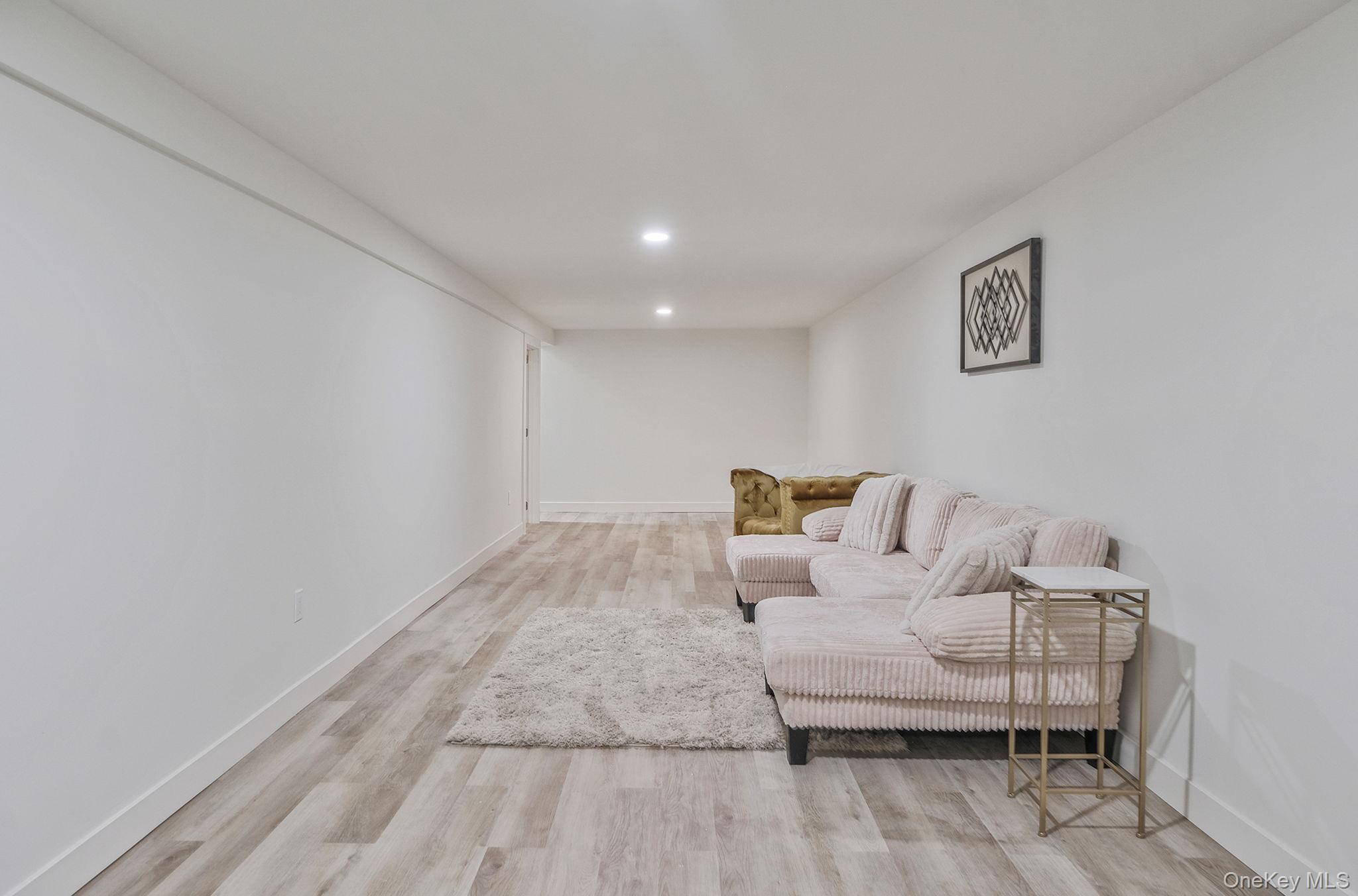 120 Manhattan Avenue West Babylon, NY 11704 - Photo 27 of 32 a living room with furniture and a wooden floor