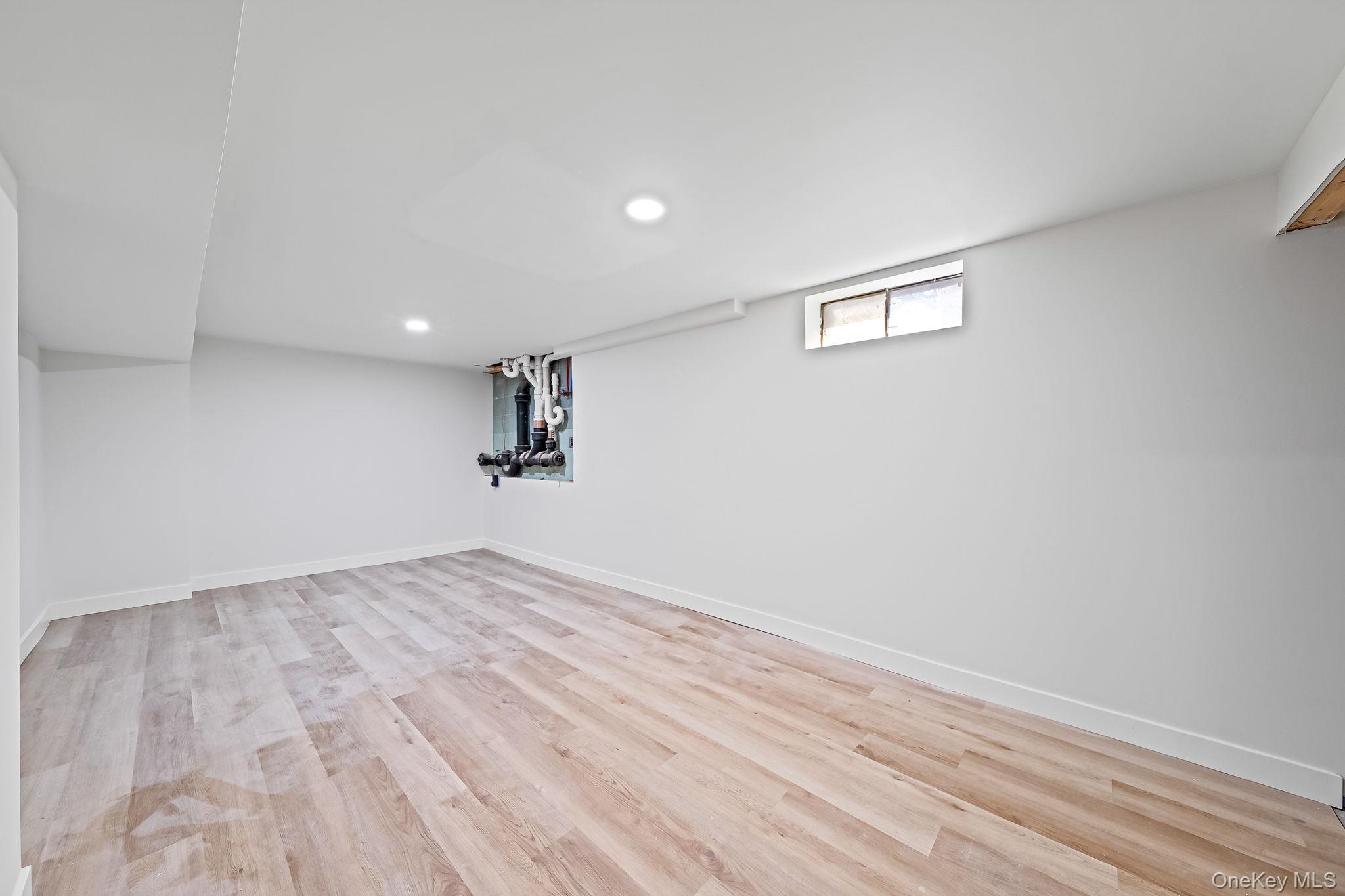 120 Manhattan Avenue West Babylon, NY 11704 - Photo 28 of 32 a view of empty room with wooden floor