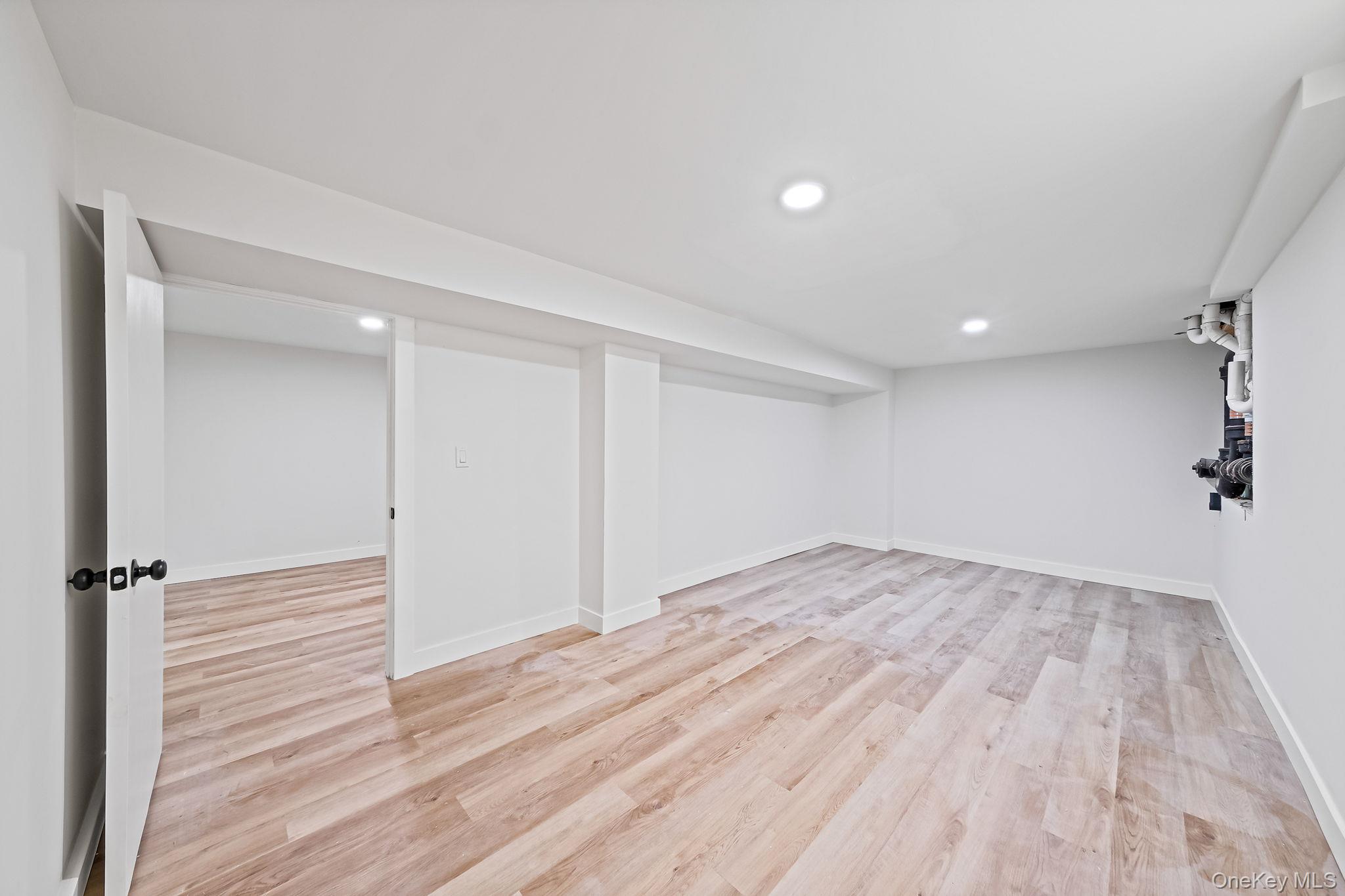 120 Manhattan Avenue West Babylon, NY 11704 - Photo 29 of 32 a view of empty room with wooden floor
