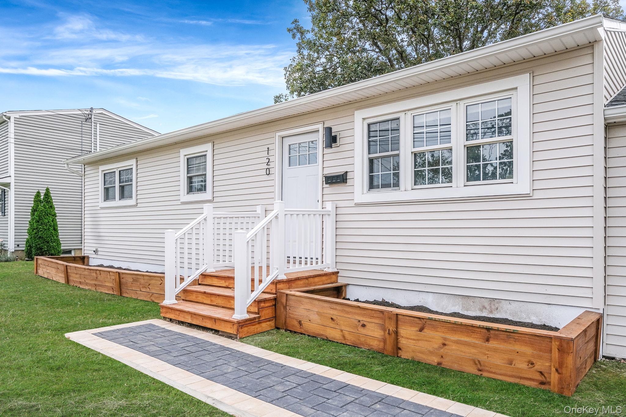 120 Manhattan Avenue West Babylon, NY 11704 - Photo 4 of 32 a backyard of a house with wooden floor and fence