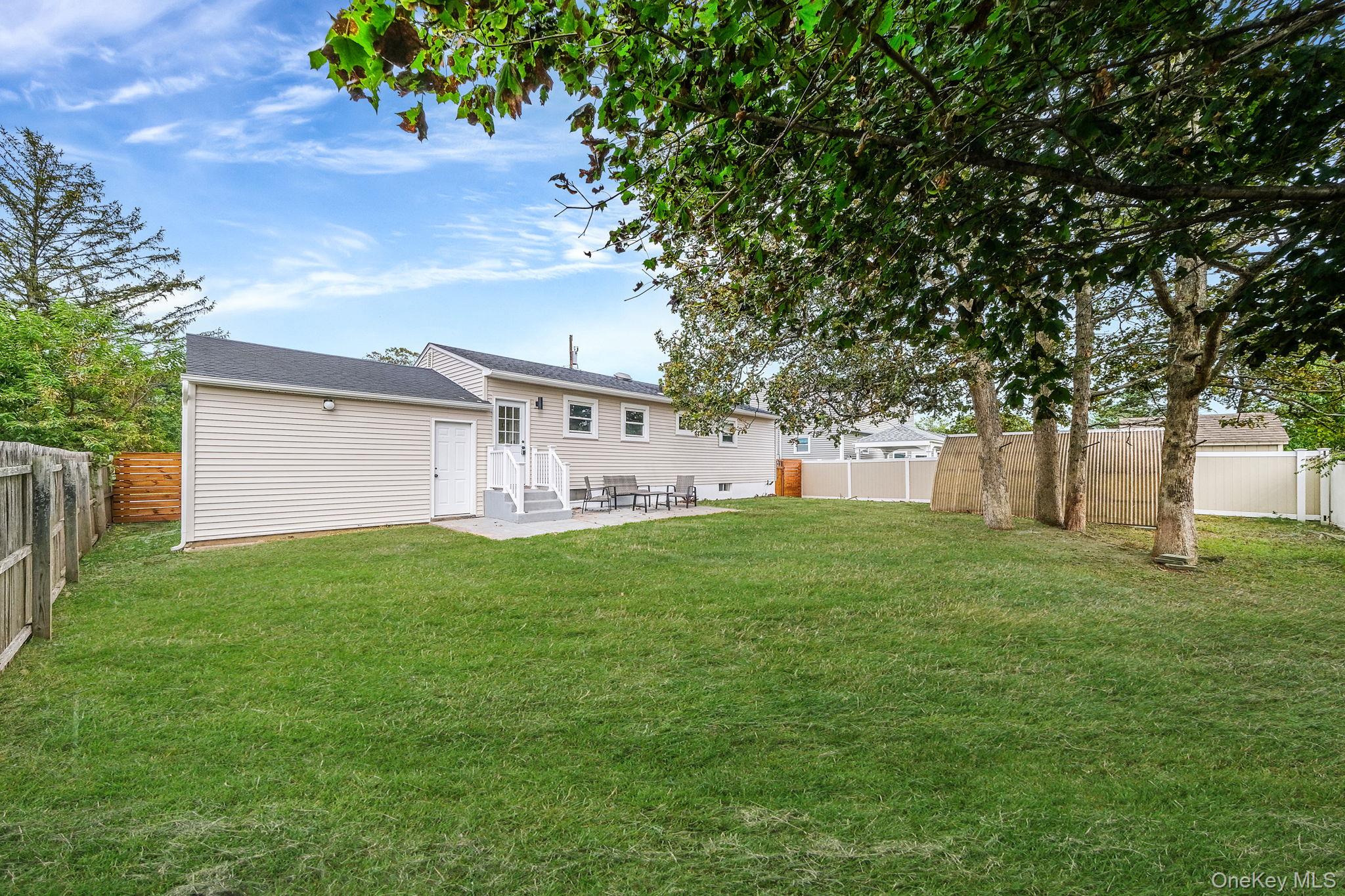 120 Manhattan Avenue West Babylon, NY 11704 - Photo 7 of 32 a view of a backyard with a garden