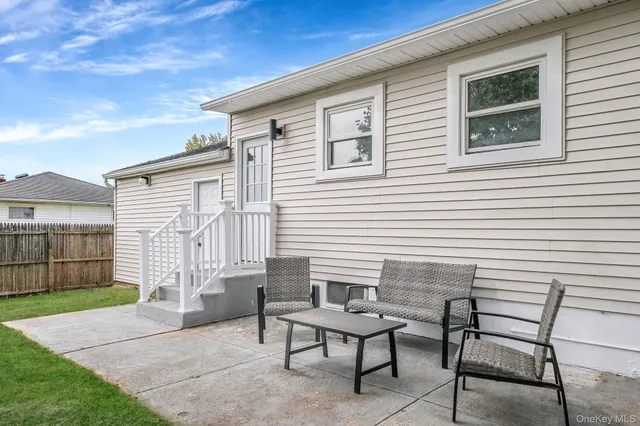 a view of a house with backyard and sitting area