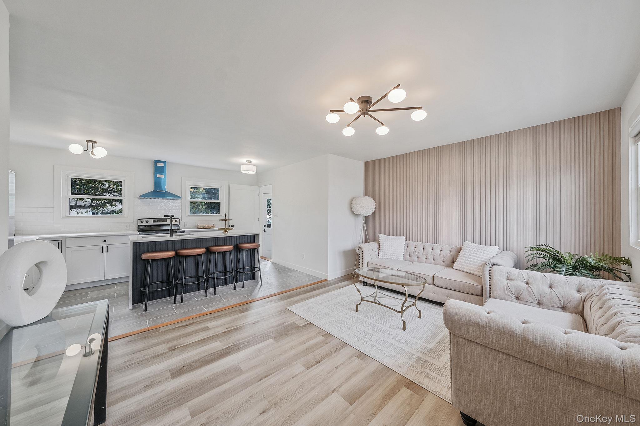 120 Manhattan Avenue West Babylon, NY 11704 - Photo 9 of 32 a living room with furniture kitchen view and a wooden floor