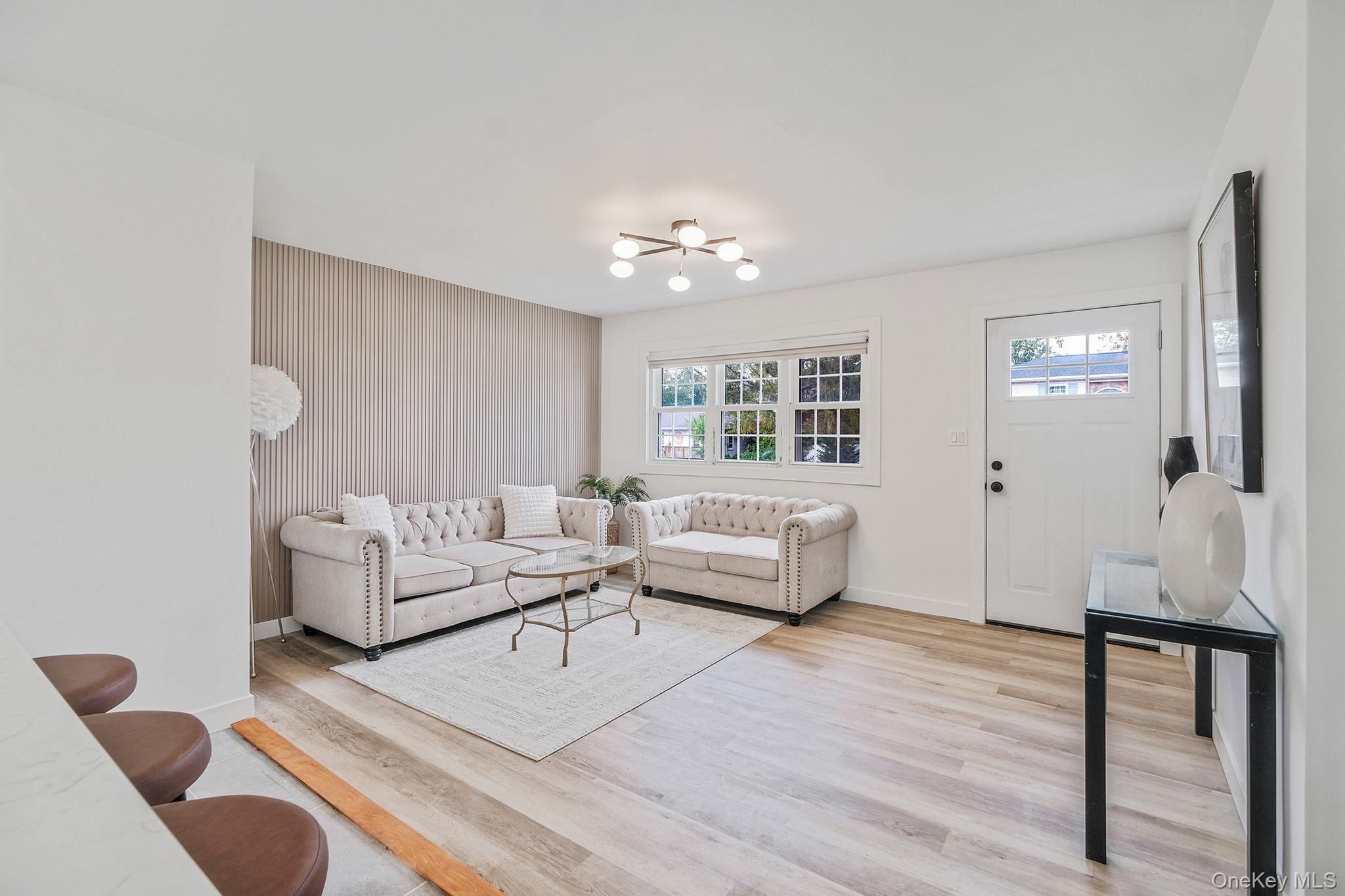 120 Manhattan Avenue West Babylon, NY 11704 - Photo 10 of 32 a living room with furniture and a large window