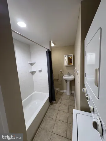 a bathroom with a glass door shower a toilet and a sink