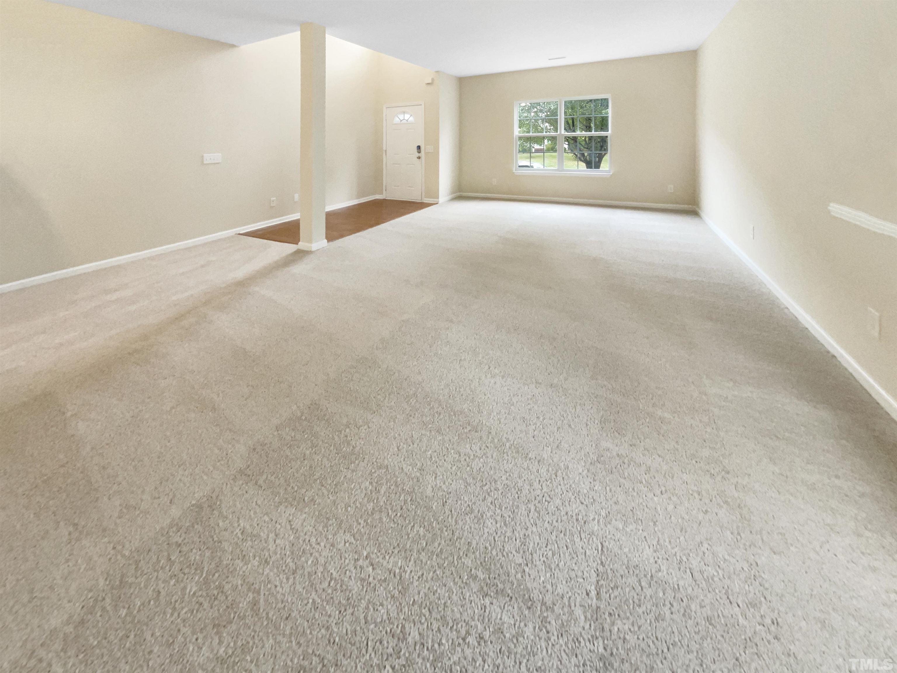 5408 Neuse Planters Court Raleigh, NC 27616 - Photo 6 of 17 a view of a big room with windows and chandelier fan