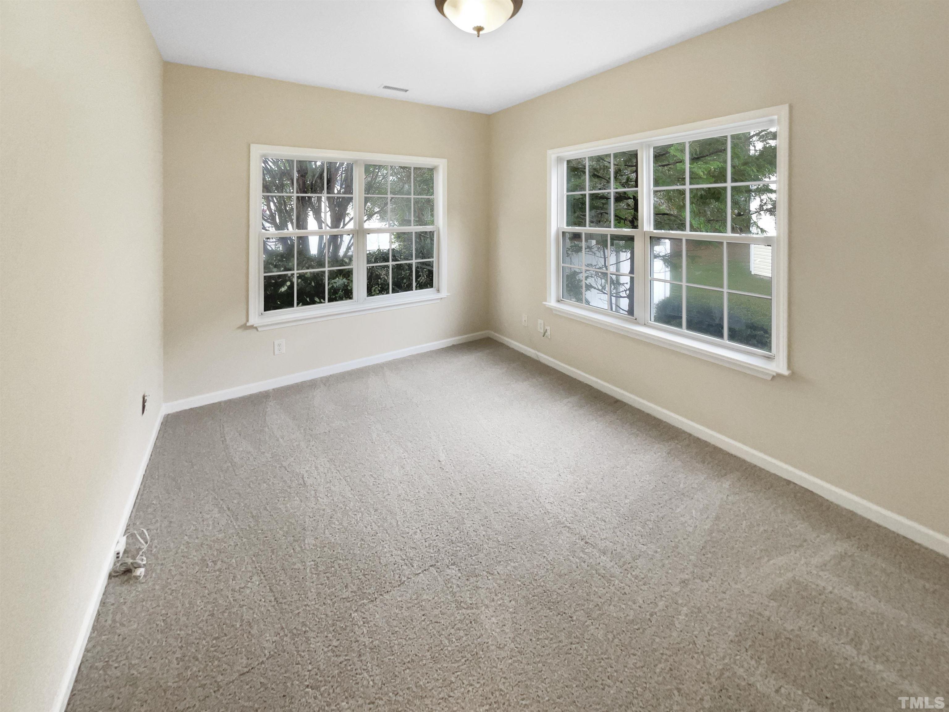 5408 Neuse Planters Court Raleigh, NC 27616 - Photo 7 of 17 an empty room with windows