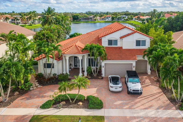 an aerial view of residential houses with outdoor space and swimming pool