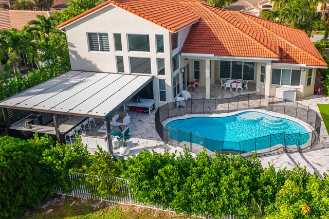 a view of a porch with chairs and potted plants