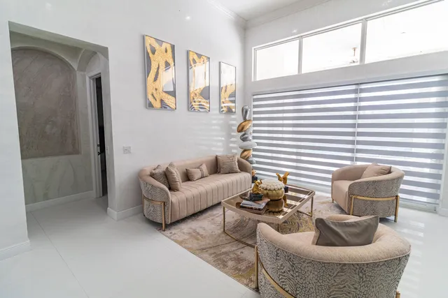 a living room with stainless steel appliances kitchen island granite countertop furniture and a fireplace