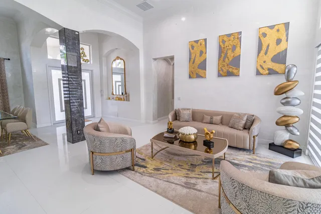 a kitchen with stainless steel appliances granite countertop a sink chairs and white cabinets