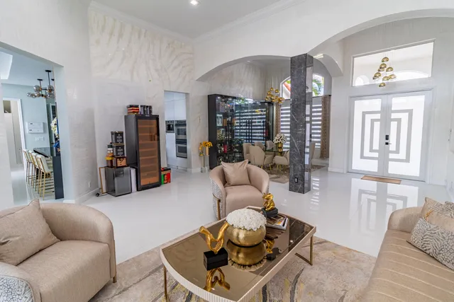 a bedroom with furniture and a large window