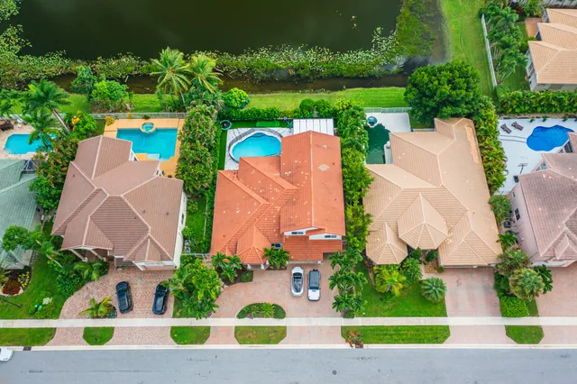 an aerial view of a house with a yard and outdoor seating