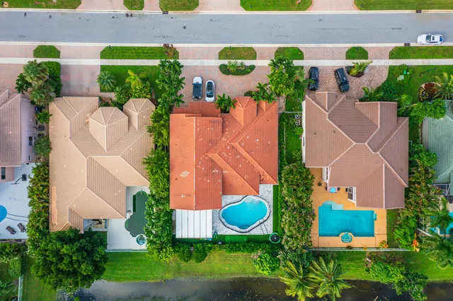 an aerial view of a house with outdoor space and pool