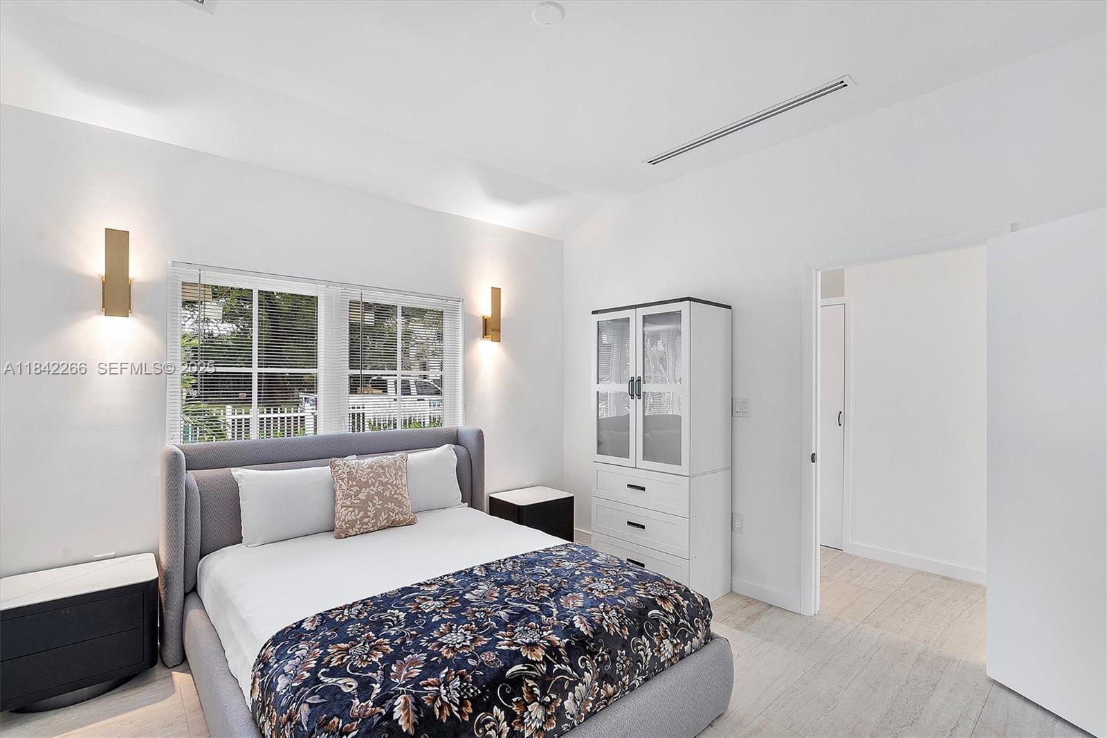 58 Northeast 45th Street Miami, FL 33137 - Photo 14 of 55 a bedroom with a large bed and wooden floor