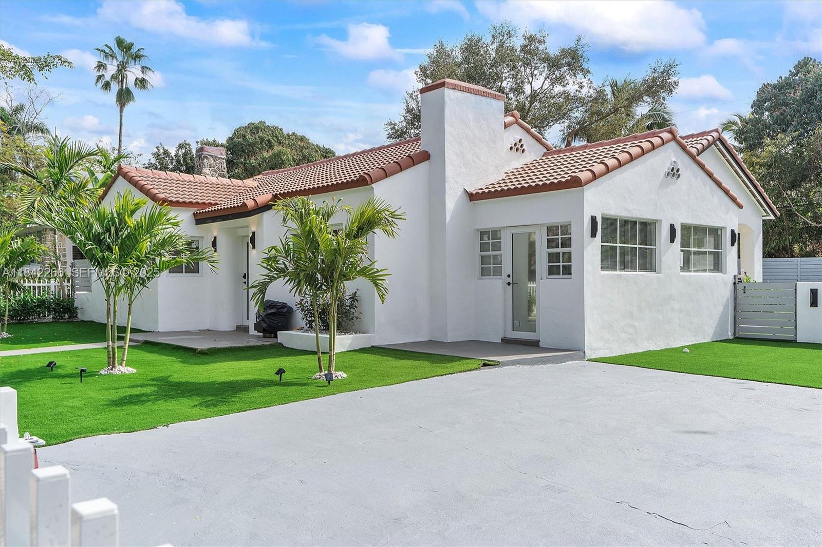 58 Northeast 45th Street Miami, FL 33137 - Photo 17 of 55 a front view of a house with a garden and plants