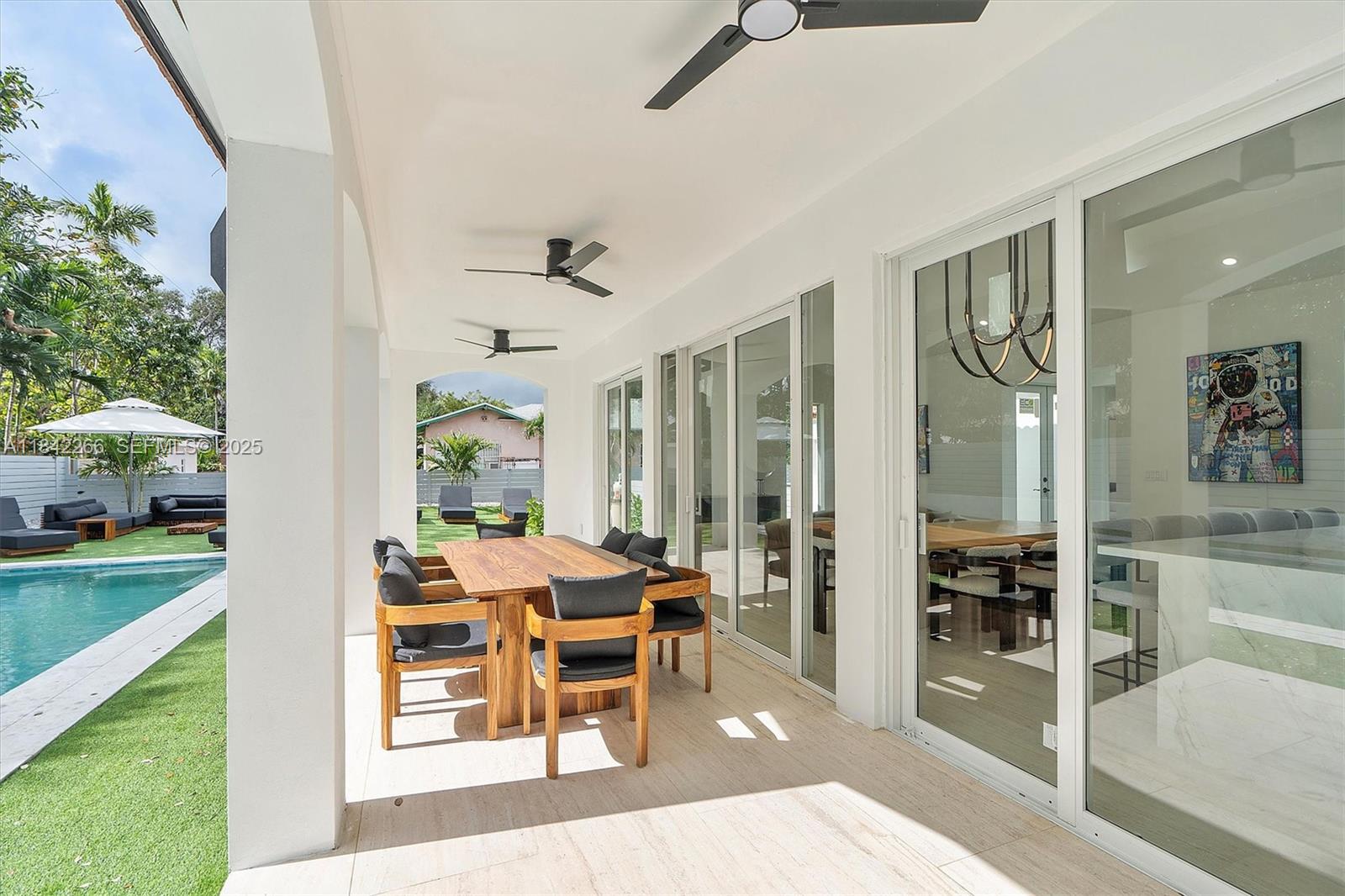 58 Northeast 45th Street Miami, FL 33137 - Photo 30 of 55 a view of a dining room with furniture window and wooden floor